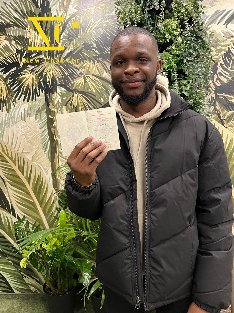West African client holding his Polish visa stamp