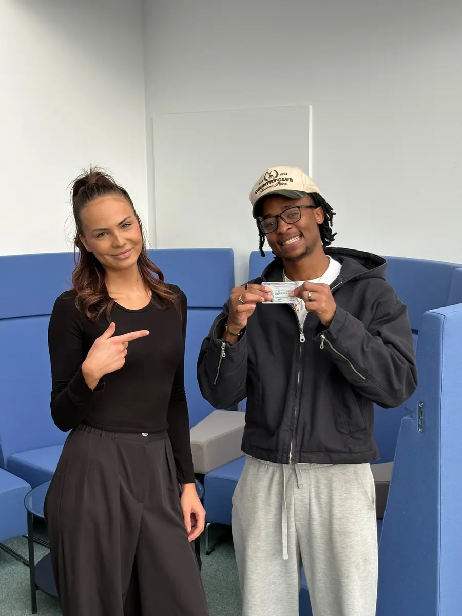 New Chapter Law lawyer with a happy client holding his approved Polish residence card